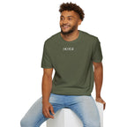 Man wearing a green t-shirt with a small graphic on a white background