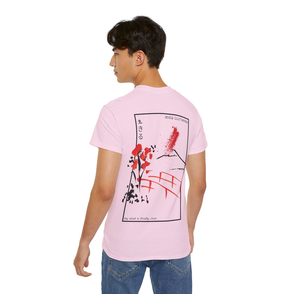 Person wearing a pink t-shirt with a graphic design on the back, standing against a white background