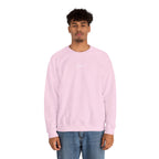 Person wearing pink sweater with IKIRU logo on a white background