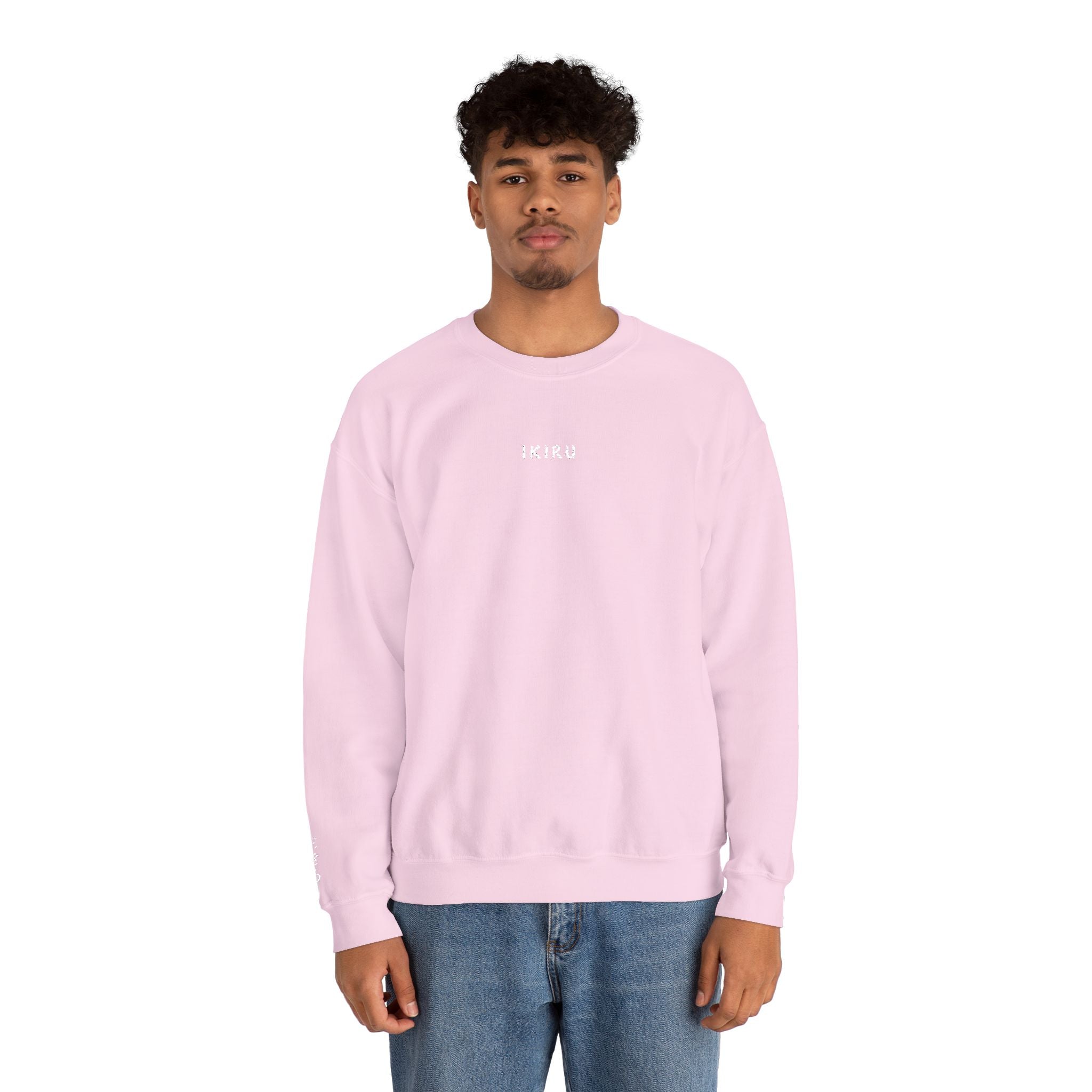 Person wearing pink sweater with IKIRU logo on a white background