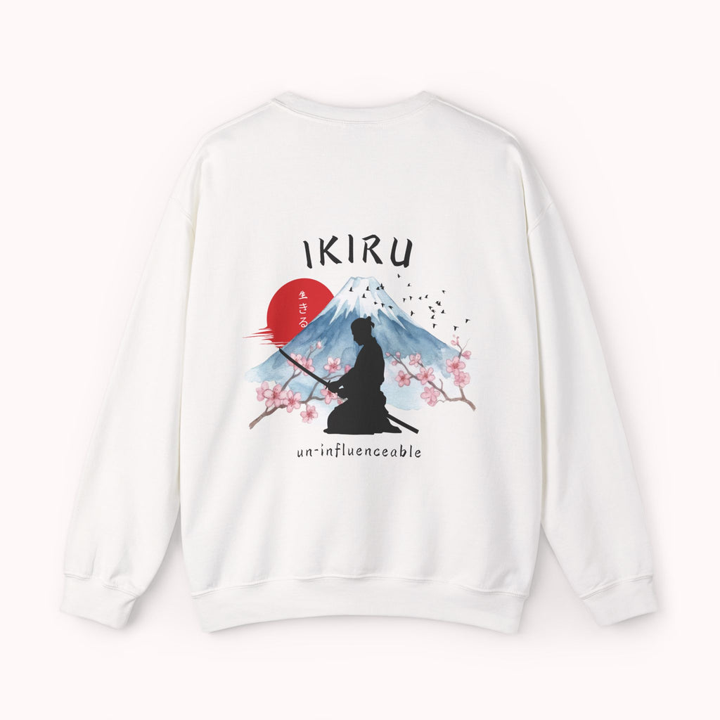 White sweater with a mountain, samurai, and blossom tree design on the back saying 'un-influenceable' against a white background