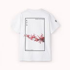 White t-shirt with cherry blossom design and IKIRU text on a white background