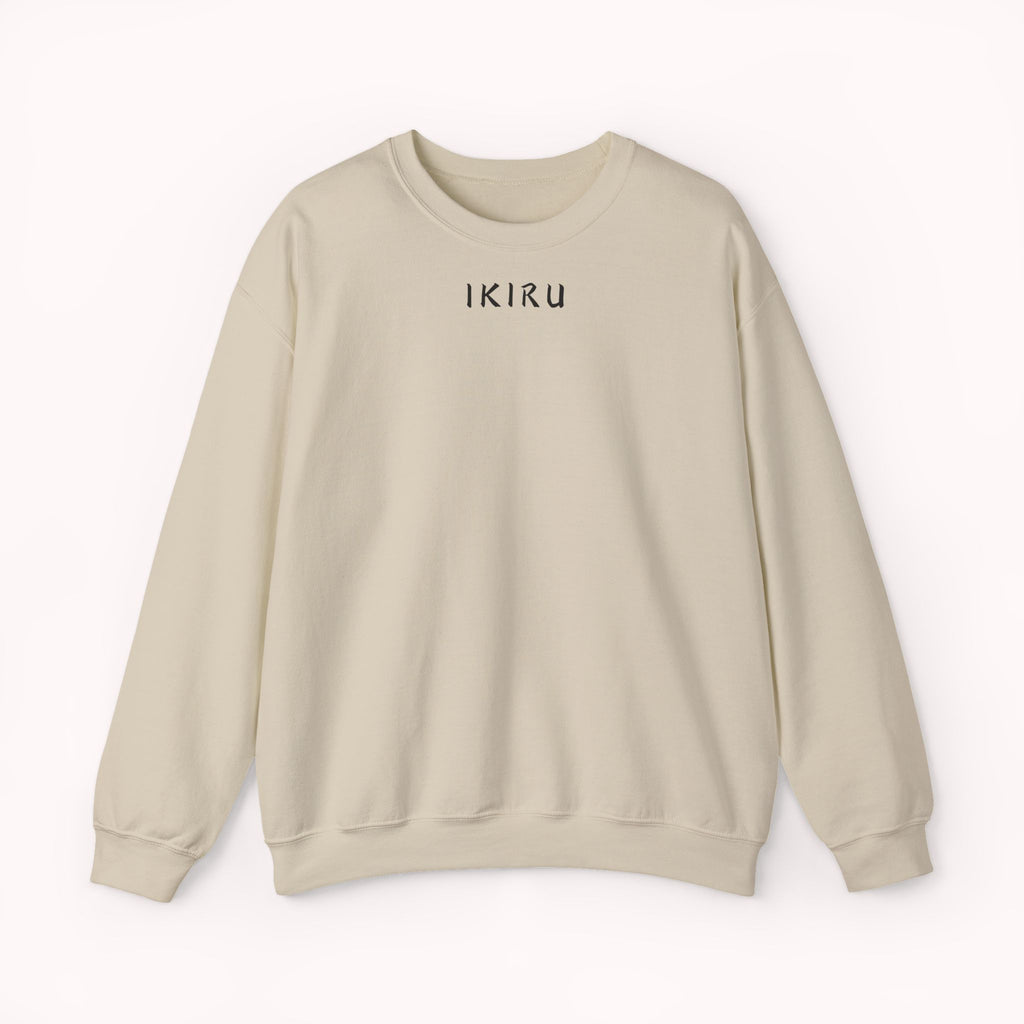 Beige sweater with a mountain, samurai, and blossom tree design on the back saying 'un-influenceable' against a white background