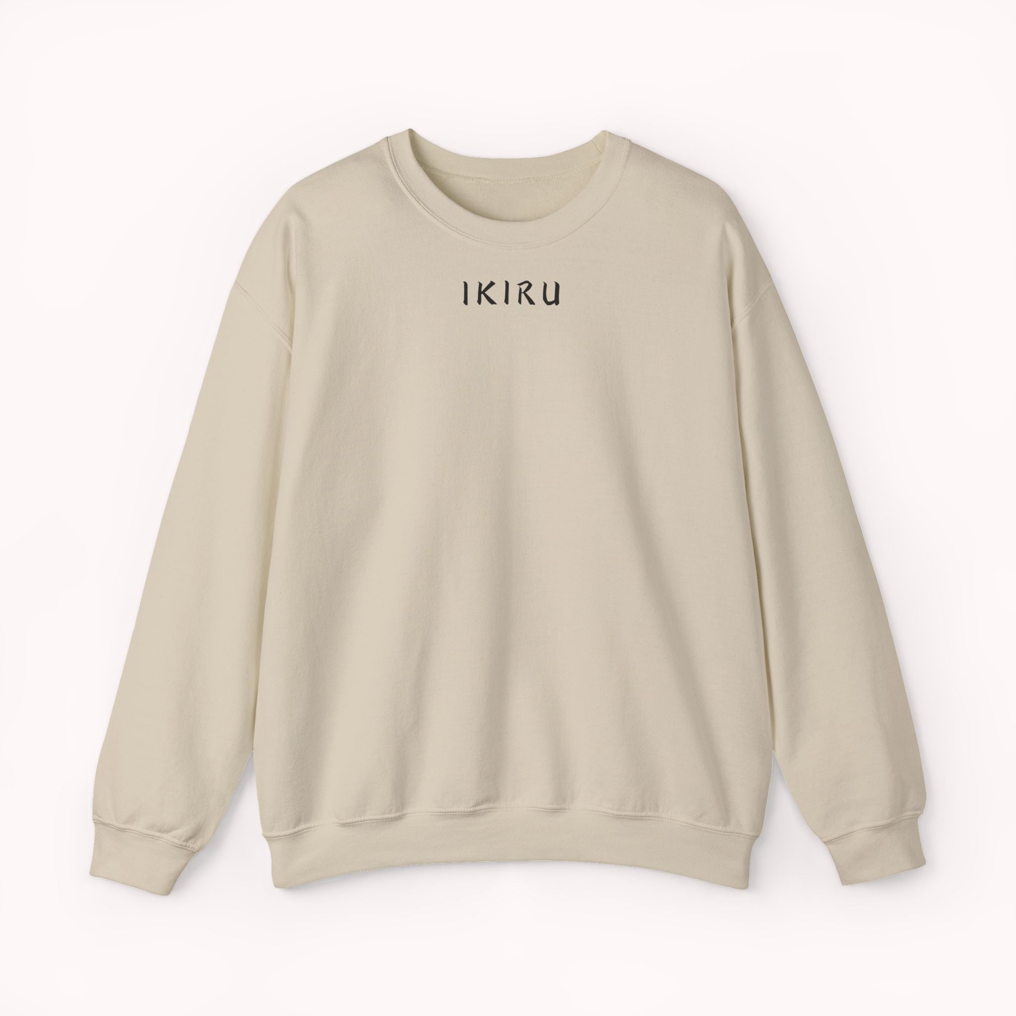 Beige sweater with a mountain, samurai, and blossom tree design on the back saying 'un-influenceable' against a white background