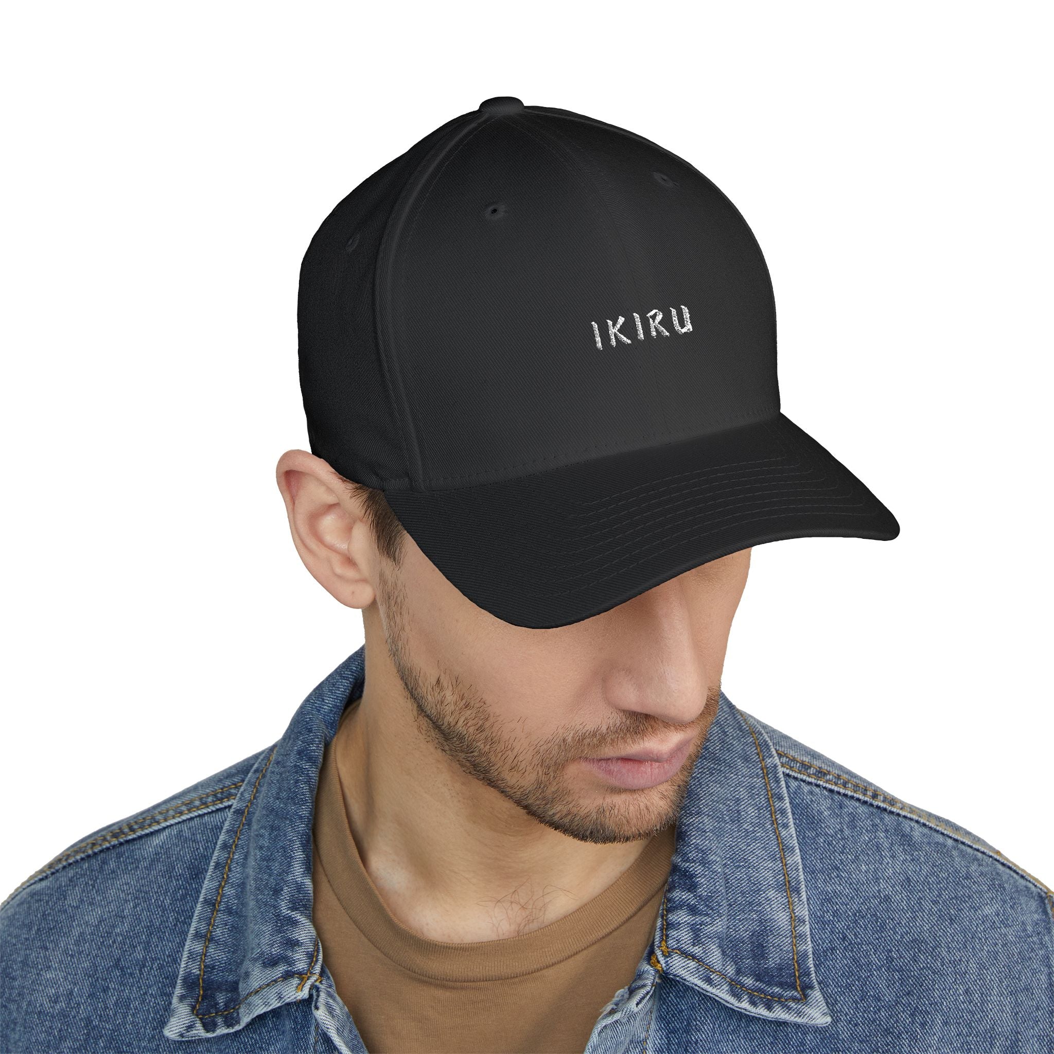 Black cap with 'IKIRU' logo worn by a person on a white background