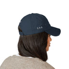 Person wearing a navy blue cap with text on a white background