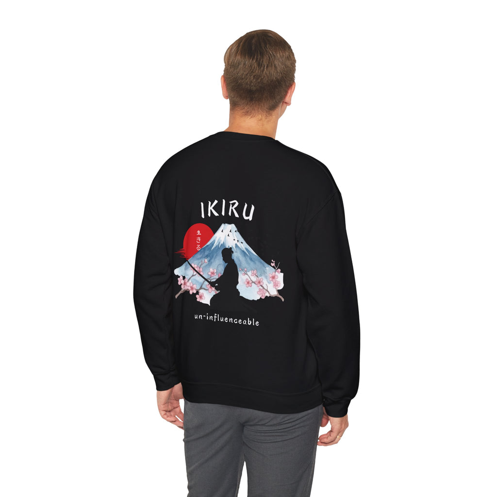 Man wearing white sweater with a mountain, samurai, and blossom tree design on the back saying 'un-influenceable' against a white background