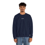 Person wearing a navy blue sweatshirt with IKIRU logo on a white background