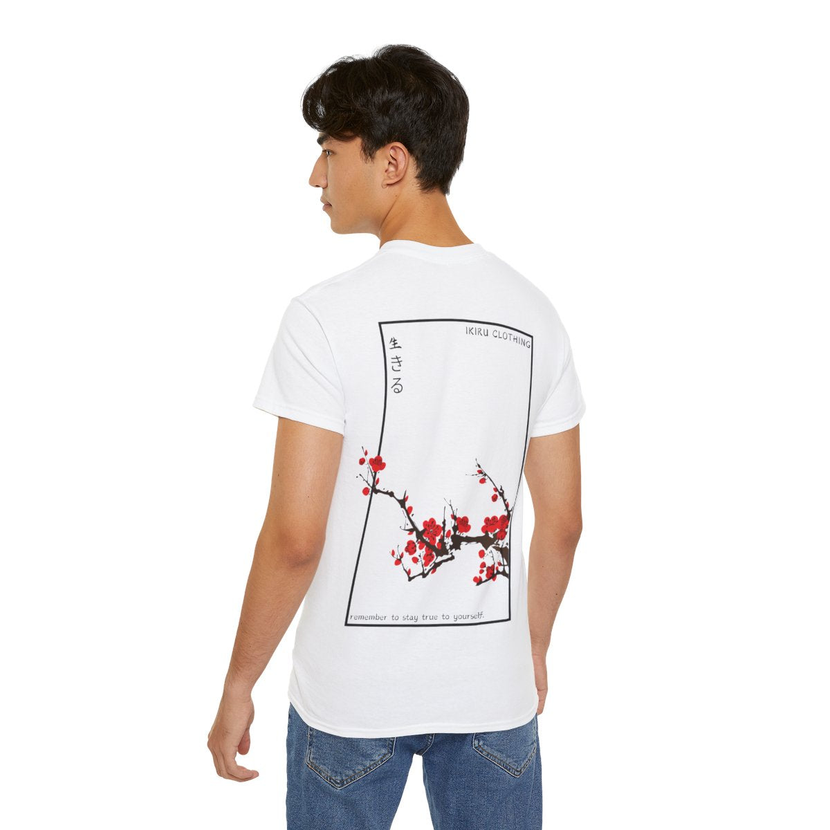 Person wearing a white t-shirt with Japanese cherry blossom design from 'IKIRU CLOTHING' on a white background